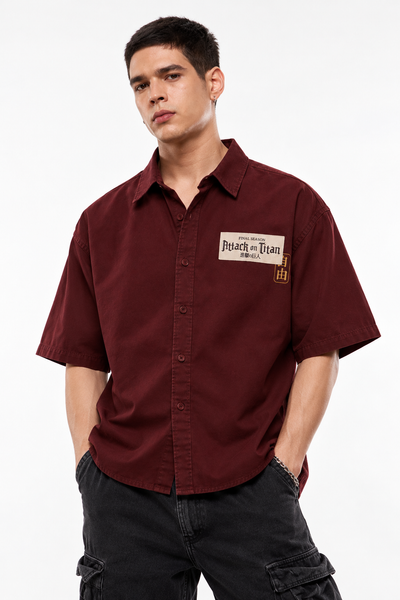 Front view of oversized maroon Attack on Titan shirt on model, white studio background