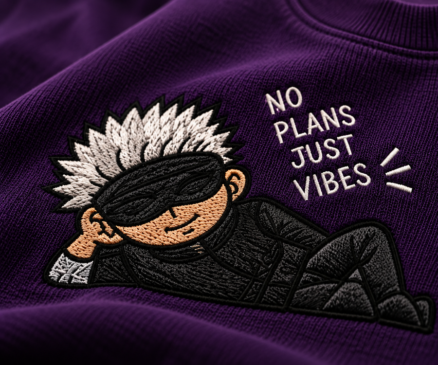 Close-up of embroidered Gojo inspired chest graphic on deep purple French terry T-shirt