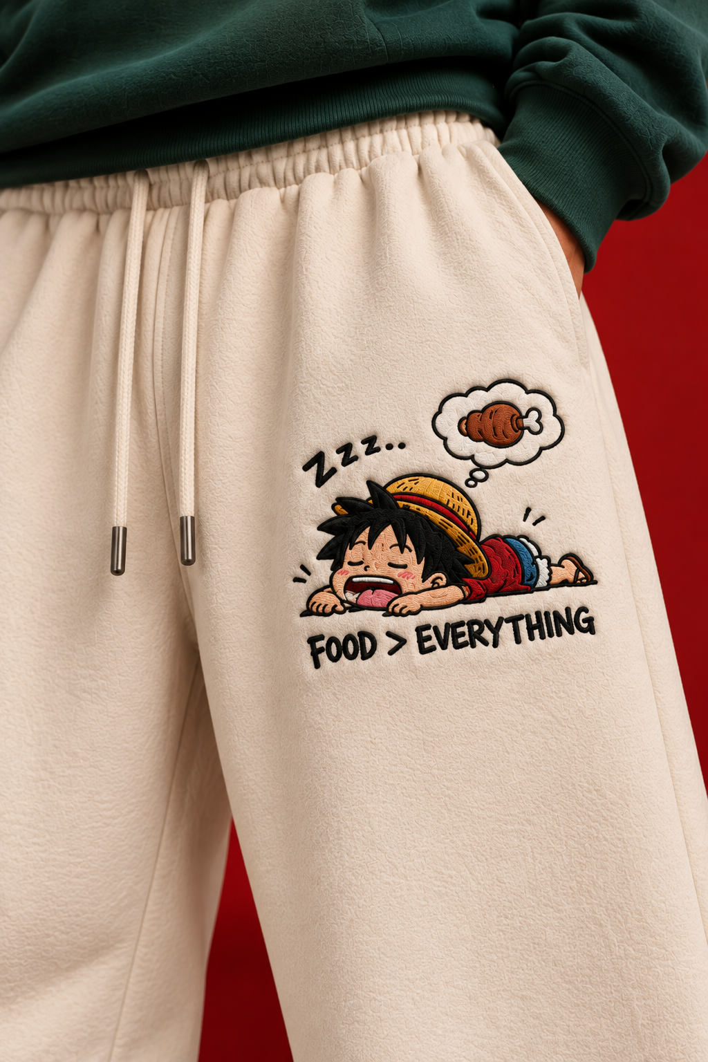 Close-up anime embroidery on cream sweatpants
