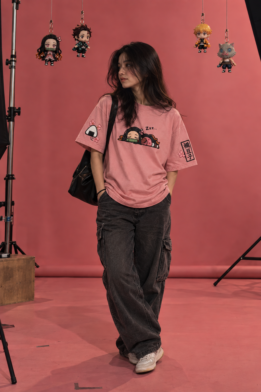 Nezuko anime oversized T-shirt worn by model in pink studio