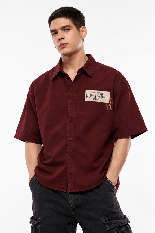 Front view of oversized maroon Attack on Titan shirt on model, white studio background