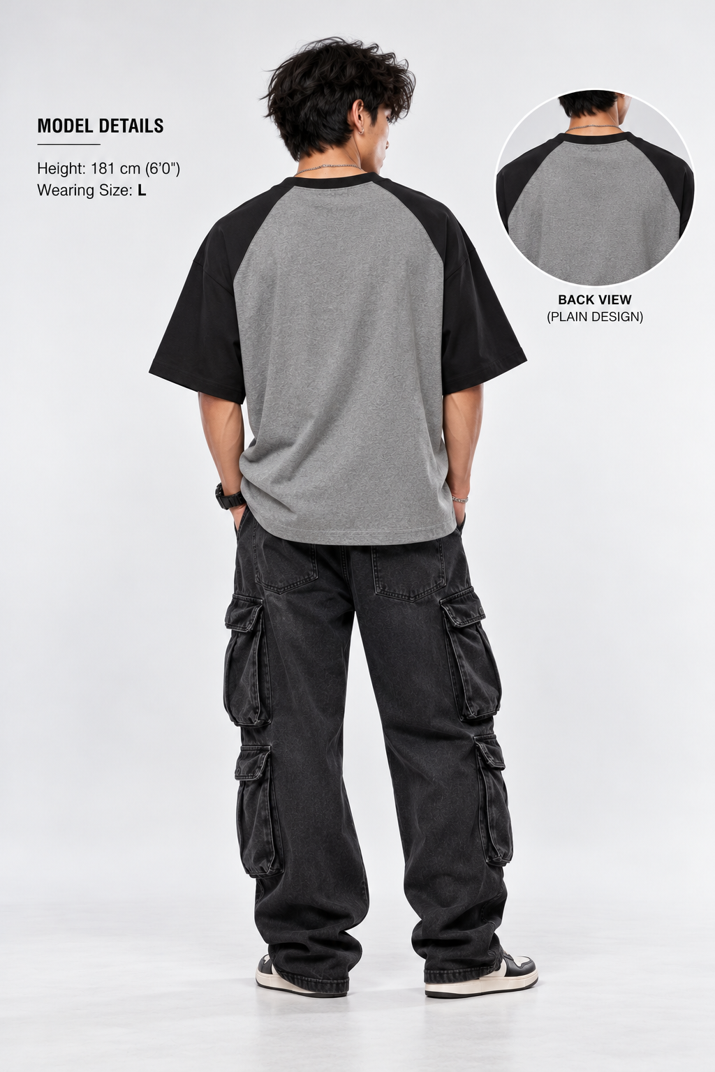 Plain back view of gray and black oversized raglan shirt on model