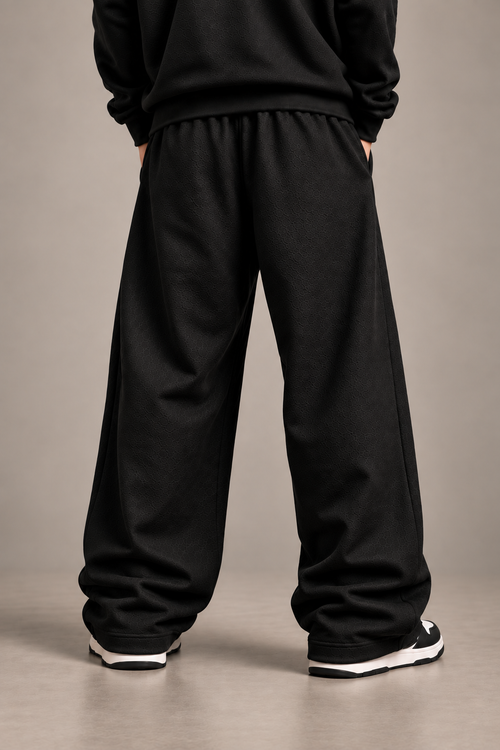 Black anime embroidered sweatpants back studio shot